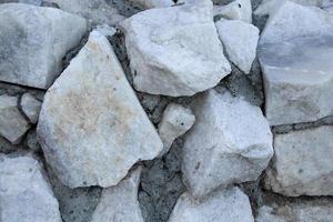 wall of white large stone with cement photo