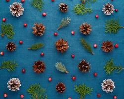 Christmas and Happy New Year dark blue background. Pattern with fir branches, cones, cranberry