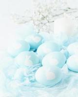 Easter. Holiday. Light white background, gentle pastel colors. Flowers in background, side view photo