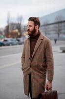 Business portrait of standing man in outdoor. Looking away. Vertical image. photo