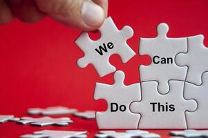 We can do this text on jigsaw with one hand holding a missing jigsaw pieces. Business and teamwork concept photo