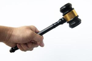 Hand holding Gavel with white background. Law concept photo