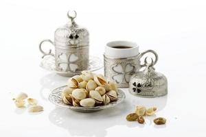 Roasted Pistachio Nuts Served with Turkish Tea photo