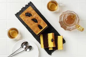 Lapis Surabaya or Surabaya Layer Cake is three layers rich egg yolk sponge cake with strawberry jam in between photo