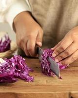 Chopped red cabbage close-up on kitchen board. photo