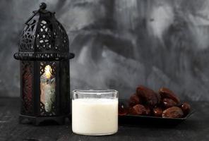 Susu Kurma or Dates Fruit Smoothie Made from Milk and Dates Palm Fruits, on Wooden Background photo