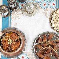 Ramadan Lebaran Eid Al Fitr Snack Dessert, Oum Ali, Dates Fruit, Pistachio, and Tea photo