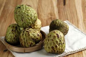 Buah Srikaya. The sugar-apple, or sweetsop, is the fruit of Annona squamosa. The flesh is fragrant and sweet, creamy white photo