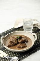 Lapis Daging, Sweet Beef Stew from East Java. Made from Boiled Beef Season with Soy Sauce. On Wooden Table photo