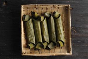 arem-arem is traditional food from java. is rice cake filled with spicy chicken, wrapped in banana leaf and steamed.