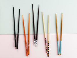 Various Pair Chopstick on Mint and Pink Background photo