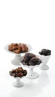 Set of Various Dates in Cake Stand, Isolated on White Background. Copy Space photo