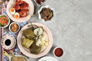 Ketupat Lebaran. Traditional Celebratory Dish of Rice Cake or Ketupat with Various Side Dishes photo