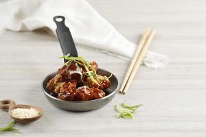 Korean Fried Chicken with Spicy Sauce and Sesame Seed photo