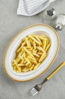 French Fries in a Bowl on a Cement Table Background, Top View