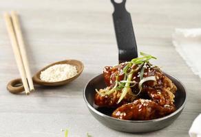 Korean Fried Chicken Yangnyeom Tongdak with Spicy Sauce and Sesame Seed. photo