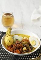Ketupat or lontong sayur, Indonesian cuisine, Special dish served at Eid Mubarak Eid Fitr celebration. photo