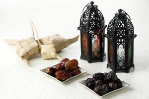 Ramadan Kareem and iftar muslim food, holiday concept. Trays with nuts and dried fruits and latterns with candles.