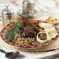 Nasi Kebuli Kabuli Rice, Arabic or India Pilaf with Beef RIbs or Lamb, on Wooden Table photo