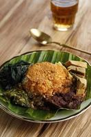 Nasi Padang Served with Rendang, Young Jackfruit Curry,  Cassava Leaves, and Sambal Hijau photo