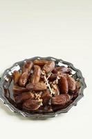 Tunisian Dates or Kurma Tunisia isolated on Cream Background for Breaking the Fast or Buka Puasa. photo