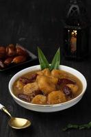 Kolak Pisang Kurma or Banana Dates Fruit Compote Made from Sliced Banana and Dates Fruit Stew in Coconut Milk and Brown Sugar. photo