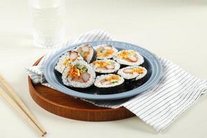 Korean Roll Gimbap Kimbob or Kimbap made from Steamed White Rice Bap and Various other Ingredients, Such As Kyuri, Carrot, Sausage, Crab Stick, or Kimchi photo