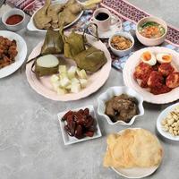 Ketupat Lebaran. Traditional Celebratory Dish of Rice Cake or Ketupat with Various Side Dishes photo