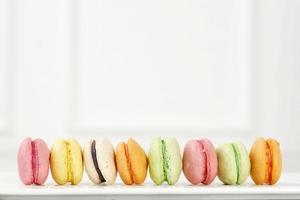 Creative layout made of colorful macaroons on the white background. photo