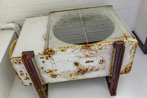 Dirty old rusted air conditioner at Naithon Beach Phuket Thailand. photo