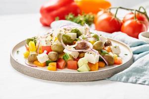 Greek village salad horiatiki with feta cheese and vegetables, vegeterian mediterranean food photo