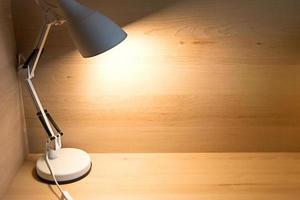 Table lamp in the loft style at the workplace at home. A place for a student to study, to work remotely. Background, copyspace. photo