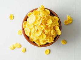 wooden bowl with dry cereal for breakfast, top view, gray background. photo