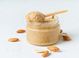 Almond butter, raw food paste made from grinding almonds into nut butter, crunchy and stir photo