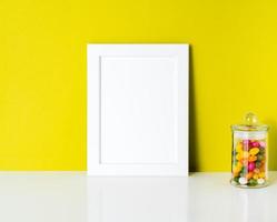 mock up frame on bright yellow paper wall photo