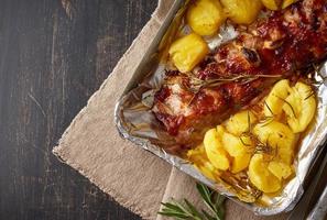 Spicy barbecue pork ribs and crushed smashed potatoes. Slow cooking recipe. photo