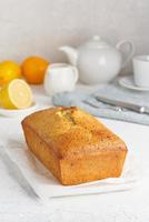 Lemon bread. Cake with citrus and poppy on cutting board, traditional american cuisine. Whole loaf