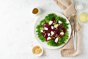 salad with beet, curd, feta, ricotta and pine nuts, lettuce. Healthy keto ketogenic dash diet photo