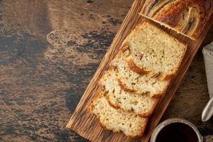 pan de banana. pastel con plátano, cocina tradicional americana. rebanadas de pan. fondo oscuro foto