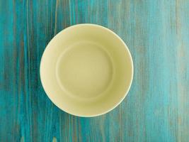 empty ceramic bowl for soup on the old wood turquoise table photo