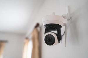 Security white CCTV Closed-circuit television camera in the house interior. CCTV in home office in the house. photo
