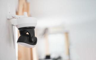 Security white CCTV Closed-circuit television camera in the house interior. CCTV in home office in the house. photo