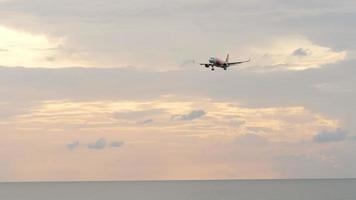 Plane AirAsia landing at sunset video