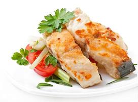 Fried filet fish and fresh vegetable salad photo