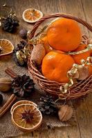 Tangerines and spices on a wooden background photo