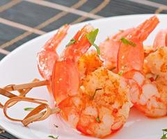 Fresh grilled shrimps with lemon on white plate photo