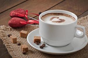 Cup of latte on the old wooden background photo