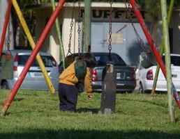 Buenos Aires, Argentina. 2021. Lonely kid hanging in a hammock photo