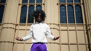 Afro American man having fun walking in city center - Happy young guy enjoying time a sunset outdoor - Millennial generation lifestyle and positive people attitude concept photo