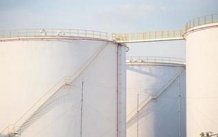 large Industrial tanks for petrol and oil with blue sky.Fuel tanks at the tank farm. metal stairs on the side of an industrial oil container. Staircase on big fuel tank
